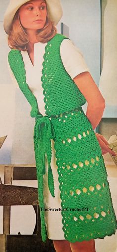 a woman wearing a green crochet apron and hat