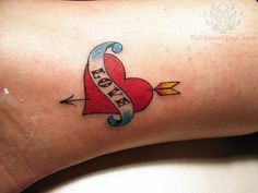 a heart with an arrow and the word love on it is shown in this tattoo