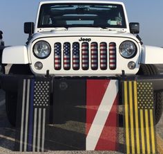 a jeep is parked in a parking lot with american flags on the front and side