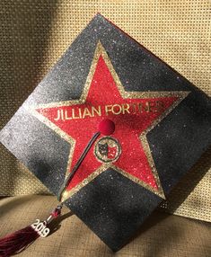 a black and red graduation cap with the name julian forted written on it in gold glitter