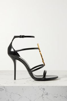 Shop SAINT LAURENT Cassandra embellished patent-leather sandals, Explore the latest SAINT LAURENT women's collection today on NET A PORTER Luxury Elegant Miu Miu Heels, Luxury Sandals With Gold-tone Hardware For Party, Luxury Party Sandals With Gold-tone Hardware, Luxury Patent Leather Sandals, Saint Laurent Shoes, Leather Buckle, High Jewelry, Black Patent Leather, Stiletto Heel