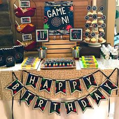 a birthday party with games on the table and cupcakes in front of it