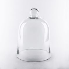 a clear glass clochel on a white background with no one around it to see the reflection