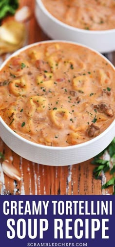 two bowls of creamy tortellini soup on a wooden table with parsley in the background