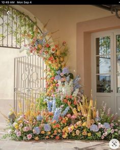 an elaborate display of flowers in front of a door