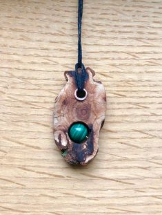 Wood pendant created from the fallen branches of the Lansdowne Sycamore. This tree is still growing and was germinated in the mid 1600s That puts this tree at around 400 years old! Other material used is a 10mm malachite bead and a copper tube rivet. Nature-inspired Tree Of Life Pendant Necklace, Rustic Pendant Necklace For Healing, Copper Tube, Malachite Pendant, Copper Tubing, Wood Pendant, Rivets, Pendant Necklaces, Native American