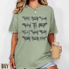 Cow Shirt | Western Graphic Tee | Cow Breed Comfort Colors Shirt | Western Shirts | Rodeo Shirt | Cow Gifts |Country Shirt |  Vintage Cows Comfort Colours Tee:  * 100% ring-spun cotton * Medium fabric (6.1 oz/yd² (206.8 g/m * Relaxed fit * Sewn-in twill label * Machine Washable  * Unisex Fit - Refer to sizing guide in photos for sizes  Care Instructions *PLEASE READ*  * Cold machine wash only on a gentle cycle with similar colours - wash garment inside out  * Use standard washing powder only; it Casual Cotton Blouse With Graphic Print, Relaxed Fit Crew Neck Blouse With Graphic Print, Relaxed Fit Cotton Blouse With Graphic Print, Cotton Graphic Print Blouse With Relaxed Fit, Cotton Blouse With Graphic Print And Relaxed Fit, Cow Tshirt, Western Graphic Tees, Rodeo Shirts, Cow Gifts