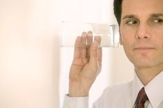 a man holding a glass of water up to his face