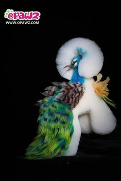 a stuffed animal with feathers on it's back