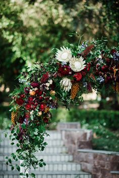 an arch decorated with flowers and greenery