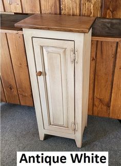 an antique white cabinet with the words antique white painted on it