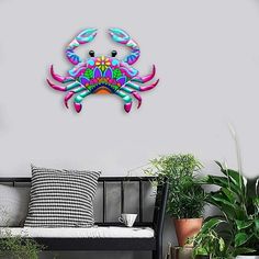 a colorful crab clock mounted to the side of a wall next to potted plants