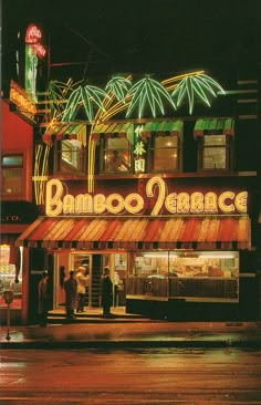 an image of a storefront at night with neon lights on it's windows