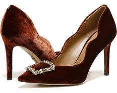 a pair of brown high heeled shoes with jewel buckles