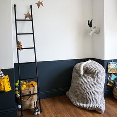 a ladder leaning against the wall in a child's room with toys on the floor