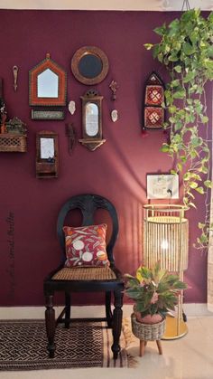 a chair sitting in front of a purple wall with lots of mirrors on the wall