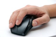 a person's hand on a computer mouse with their thumb resting on the mouse