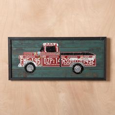 a wooden sign with a fire truck painted on it