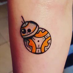 a small tattoo on the leg of a person with a star wars character in it