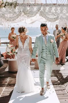 a bride and groom walking down the aisle