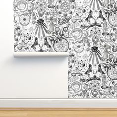 an artistic wallpaper design with black and white images on it, in the corner of a room