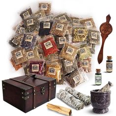 an assortment of spices and condiments are arranged on a white background with a wooden box