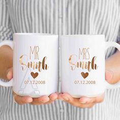 two coffee mugs that say mr and mrs smith with hearts in gold on them