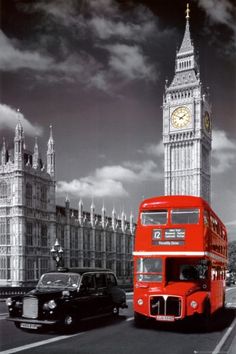 a red double decker bus driving past big ben