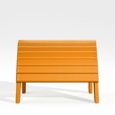 an orange bench sitting on top of a white floor