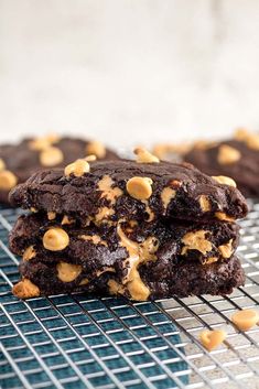 two chocolate cookies are stacked on top of each other, with peanut butter in the middle