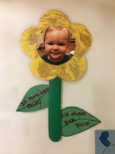 a child's face is shown in the center of a paper flower