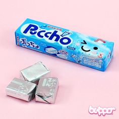 a box of paco on a pink background next to three pieces of silver foil