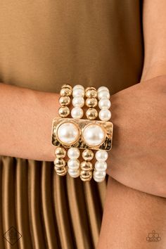 Held in place with a hammered gold frame dotted with two oversized white pearls, strands of classic gold beads and white pearls are threaded along stretchy bands that wrap around the wrist in a glamorously layered look. Sold as one individual bracelet. P9ST-GDXX-037VL RELEASED 4 OCT 20 Paparazzi Fashion, Gold Stretch Bracelet, October Fashion, Gold Pearl Bracelet, 5th Avenue, Pearl Design, Hammered Gold, Conscious Fashion, Paparazzi Accessories