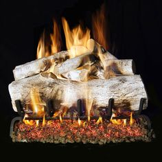 a fire pit with logs and flames in it