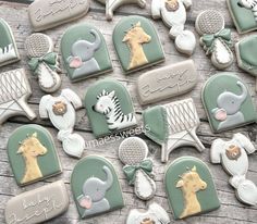 some cookies are decorated with baby items and designs on them, including giraffes