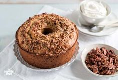 a chocolate cake with pecans next to it