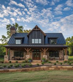 a large house with a metal roof and stone walls