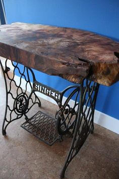 an old sewing machine table with a wooden top