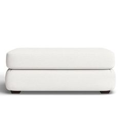 a white couch sitting on top of a wooden floor