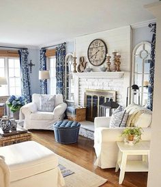 a living room filled with furniture and a clock on the wall above it's fireplace