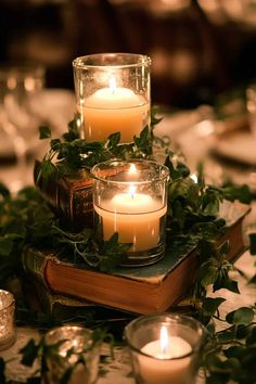 candles are lit on top of an old book