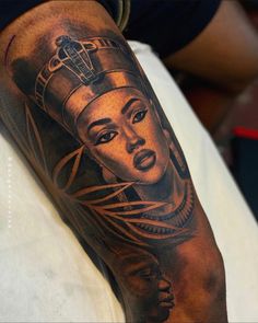 a woman's arm with an egyptian tattoo on it