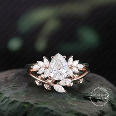 a rose cut diamond ring sitting on top of a rock