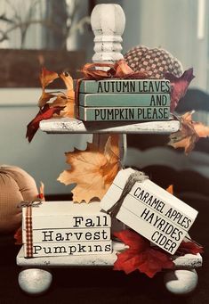 there is a sign that says autumn leaves and pumpkins on top of each other