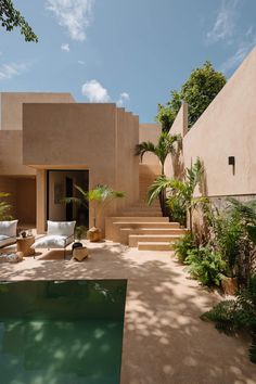 a house with a pool in front of it and stairs leading up to the outside