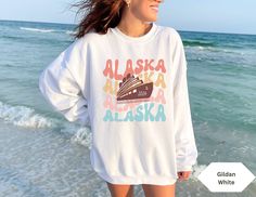 Get ready to be OBSESSED with your new Alaska Cruise sweatshirt. It's the cutest and most trendy way to emit all those fun travel vibes! Great as a gift!  * Q U I C K * F A C T S * ✺ 50% cotton 50% polyester ✺ Wash on cold and dry on low for best results. Don't iron or dryclean. ✺ This is a Gildan hooded sweatshirt.  * S I Z I N G * ✺ Models are wearing size small  ✺ Sizing is unisex so runs like men's, though not overly large ✺ Most people find their typical size works best, since they are meant to fit a touch loose ✺ For detailed sizing information and t-shirt colors, please see listing images. ✺ For the oversized look, size 1-2 sizes up from your regular sweatshirt size.  * H O W * T O * O R D E R *  ✺ Please review all Photos. ✺ Select your sweatshirt size and sweatshirt color from dro Fun Long Sleeve Tops For Vacation, White Cotton Top For Travel, White Crew Neck T-shirt For Travel, White Letter Print Top For Travel, Cotton Letter Print Travel Tops, Cotton Travel Tops With Letter Print, Cotton Letter Print Tops For Travel, White Graphic Print Top For Travel, Casual Long Sleeve Tops For Travel