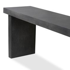 a long black bench sitting on top of a white floor