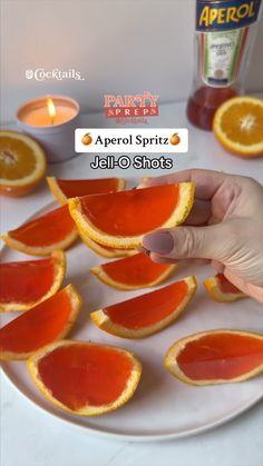 a person is holding an orange slice in front of some other orange slices on a white plate