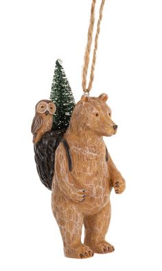 a wooden ornament with an owl and bear hanging from it's back