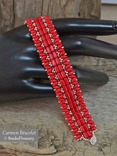 a red beaded bracelet with silver beads